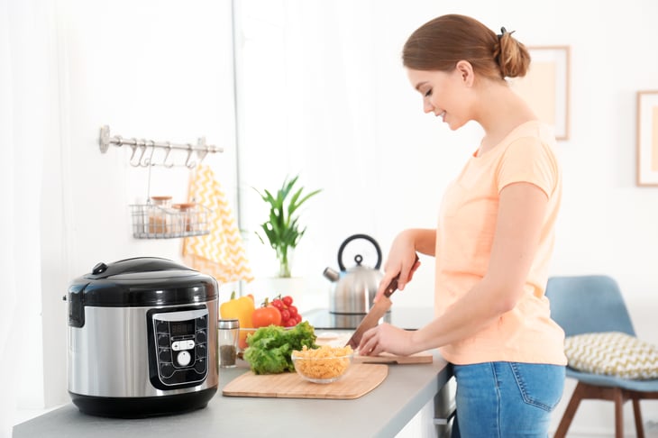 Woman preparing food for a multi-cooker