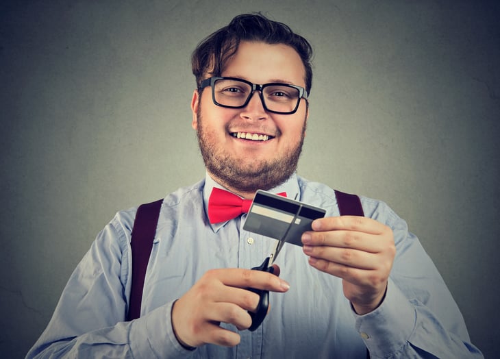 Man cutting his credit card in half