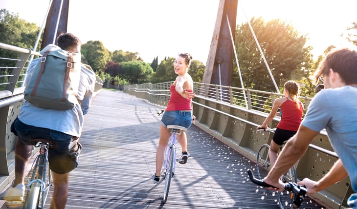 College students riding bicycles in a city