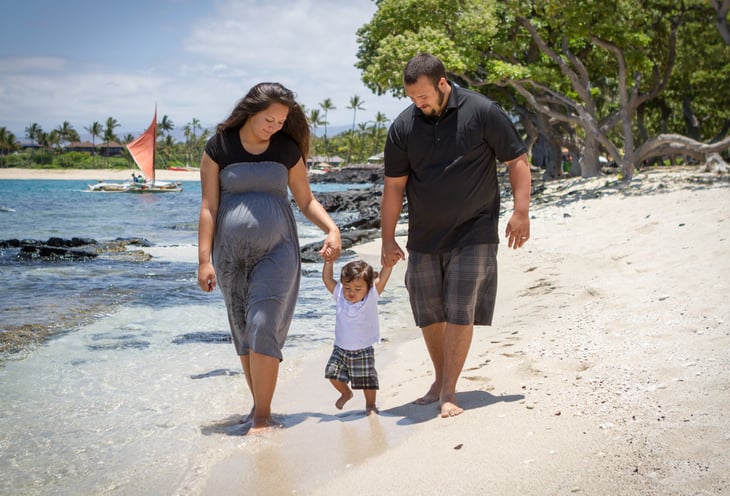 hawaii young parents teaching their toddler to walk pregnant