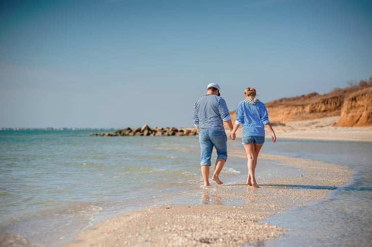 Happy couple enjoying vacation or early retirement on the beach