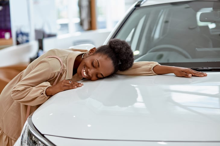 Woman hugging her car