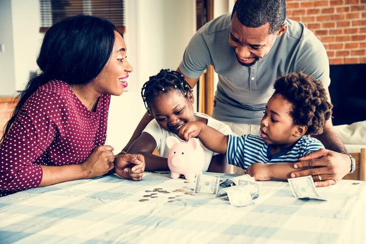 Family saving money in a piggy bank