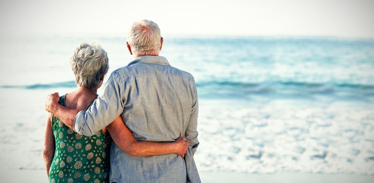 Couple standing on the shore.
