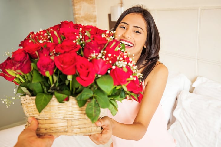 Happy woman getting flowers