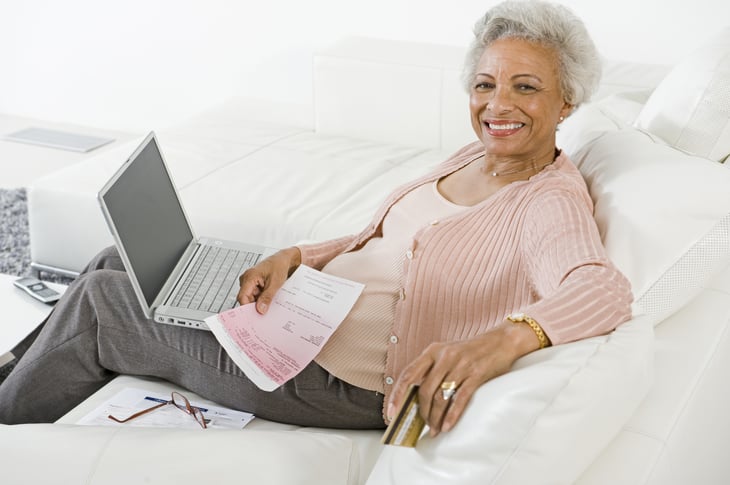 Older woman on sofa with computer