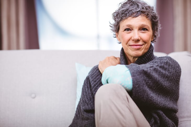 An older woman sitting on her sofa at home