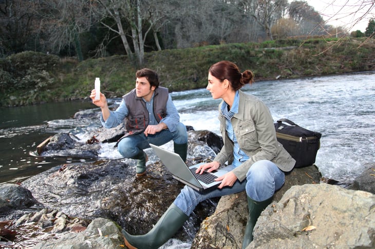 hydrologists man woman Biologists testing water river