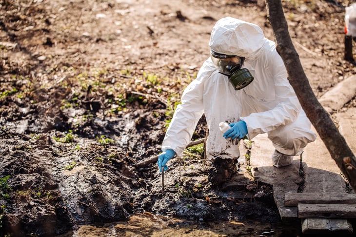 moon suit, protective clothing respirator Woman collects test tube. soil analysis, environment, ecology