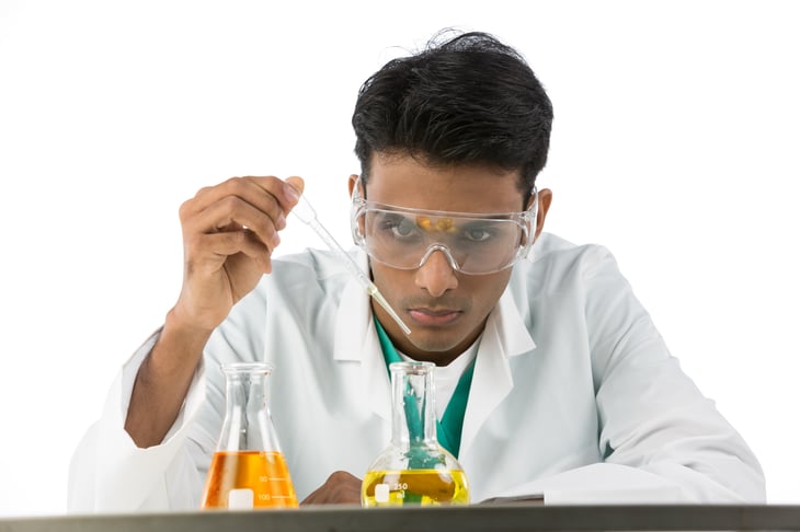 Indian male scientific researcher flask white background