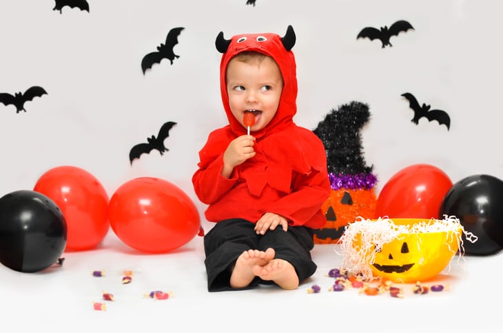 Little boy in Halloween costume with candy.