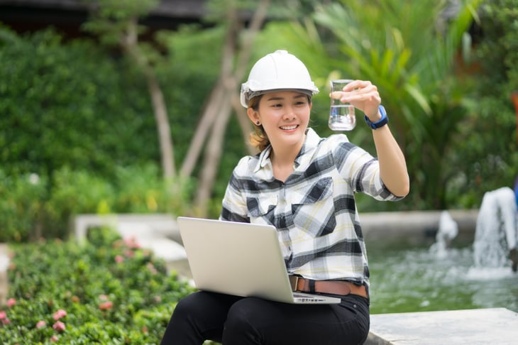 Thai Asian Female engineering working tablet laptop sewage treatment plant, engineer flask beaker water aerated activated sludge tank