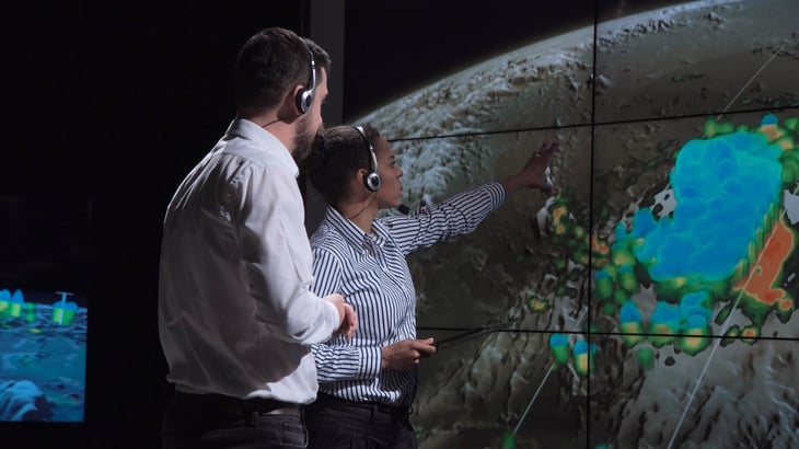 two scientists man woman african american white hurricane map and analyzing weather.