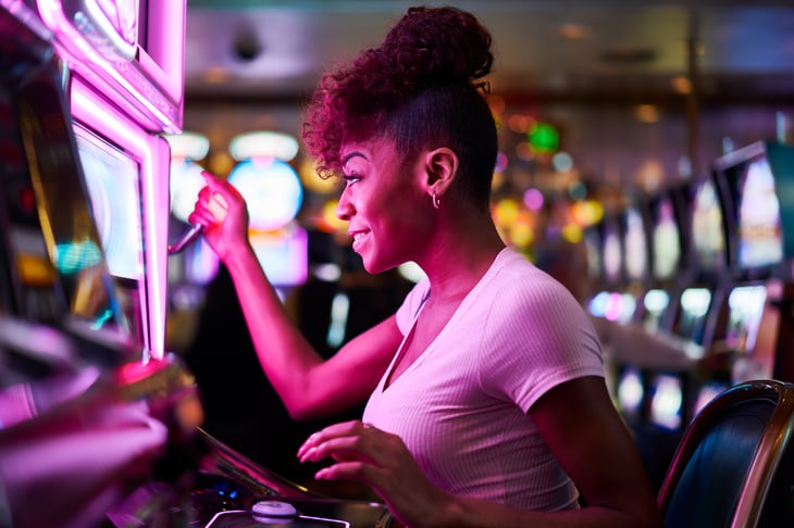 A woman gambles at a casino slot machine