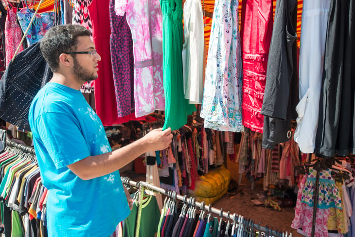 A man shops for clothing at a secondhand store