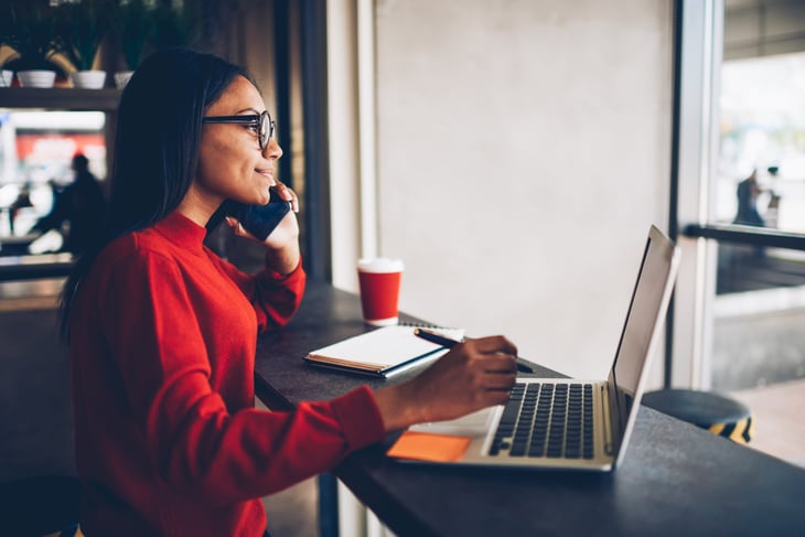 Woman on computer, cellphone