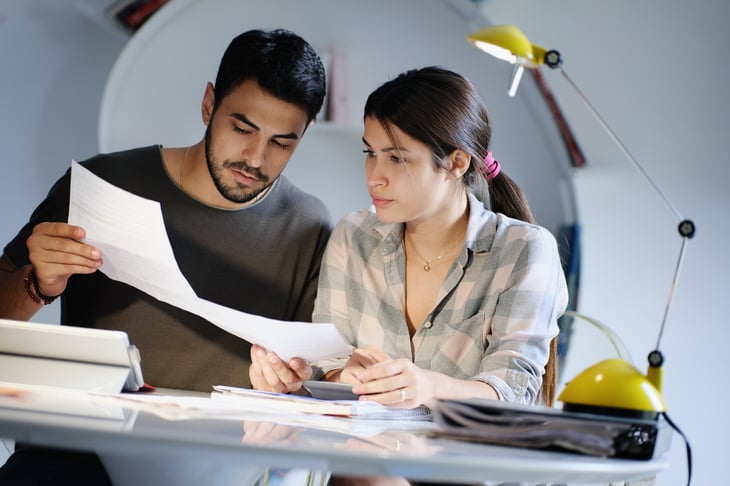 Young man woman couple reviewing family business plan tax insurance saving money retirement planning