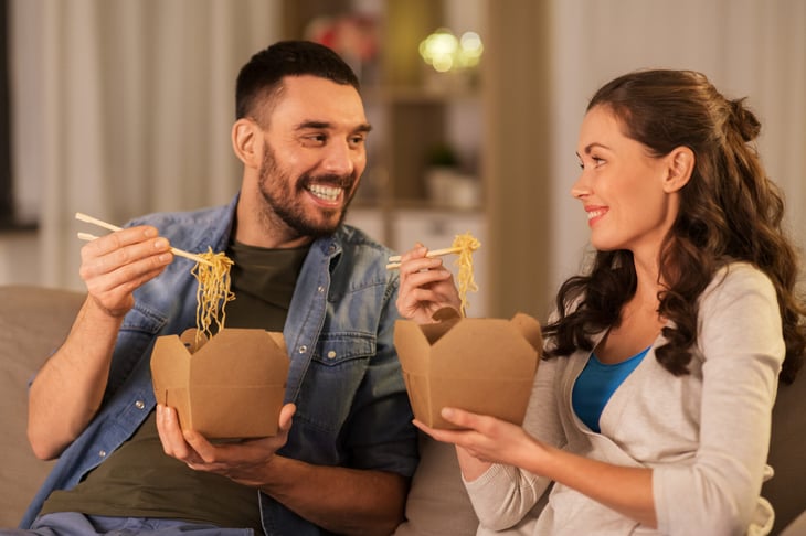 Couple eating takeout leftovers