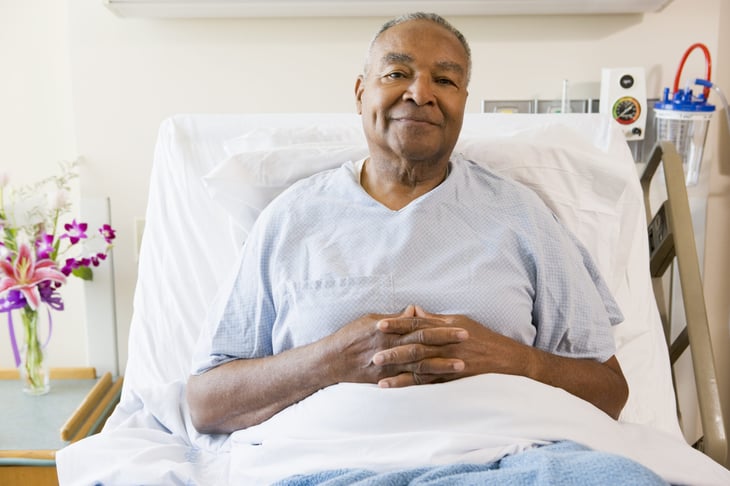 Senior man lying in a hospital bed