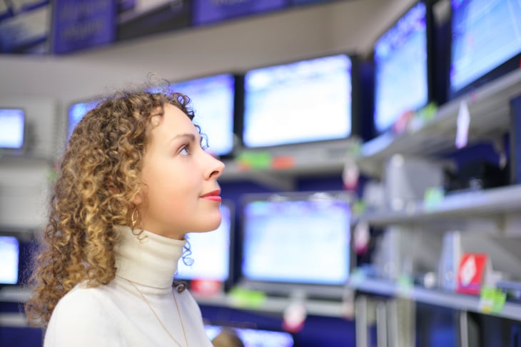 Woman looking at TVs