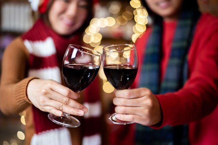 People in holiday scene, toasting.