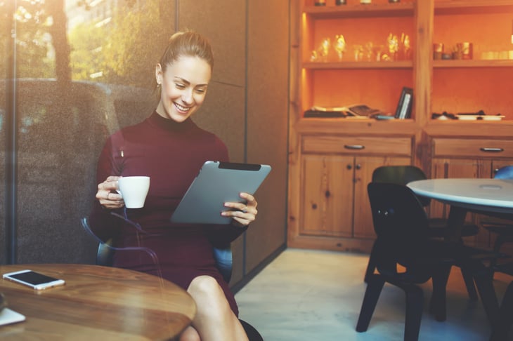 Woman with tablet and coffee