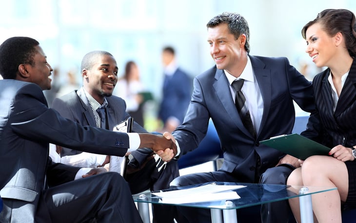 business people men woman diverse shaking hands deal agreement meeting