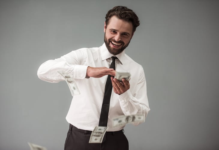 A bearded businessman makes it rain money