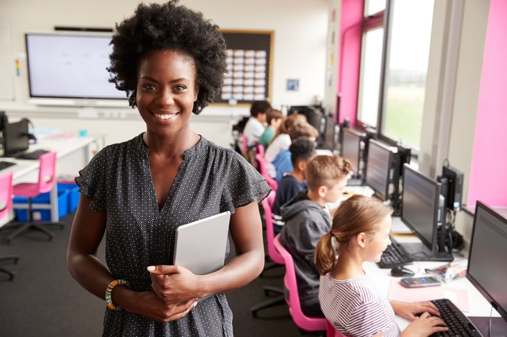 A teacher and students in a school computer lab