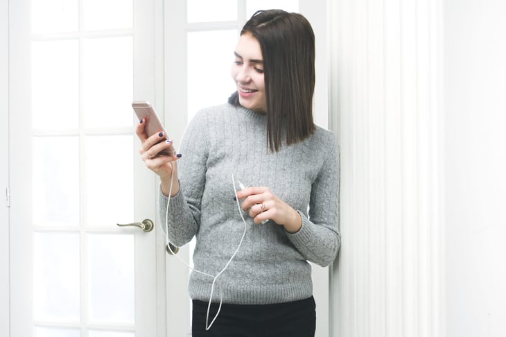 Woman using a portable phone charger