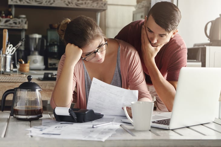 a couple stresses over their finances