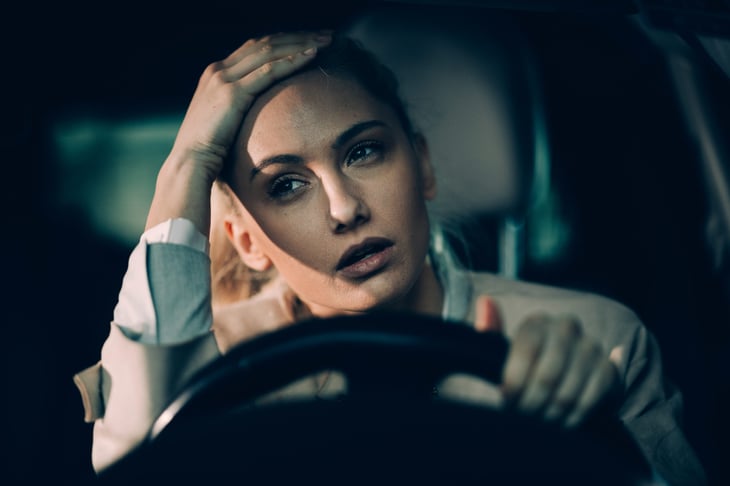 Upset woman driving a car