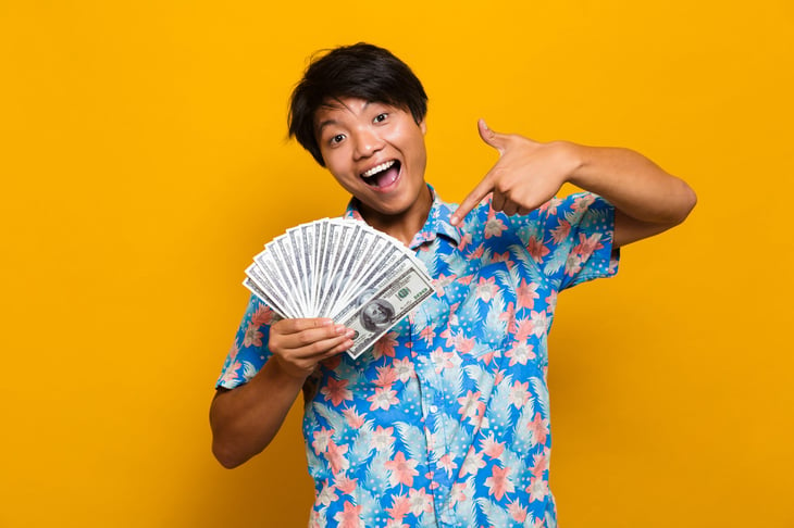Happy young man with money