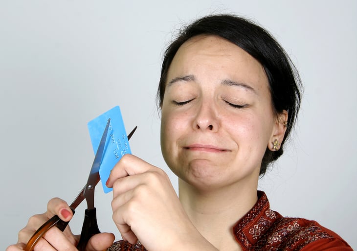 Woman cutting up credit card
