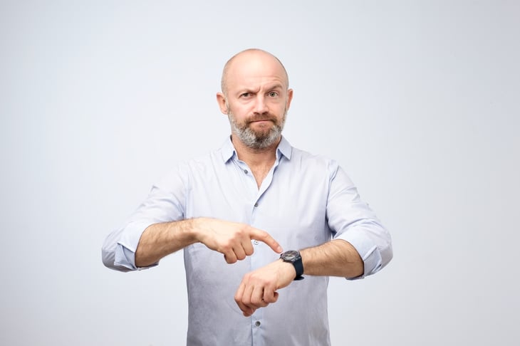 Man pointing at his watch