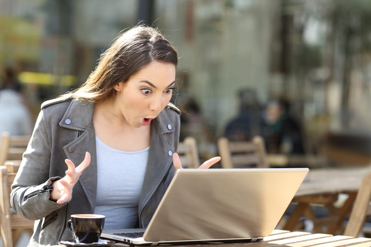 Woman surprised by a sale on her laptop
