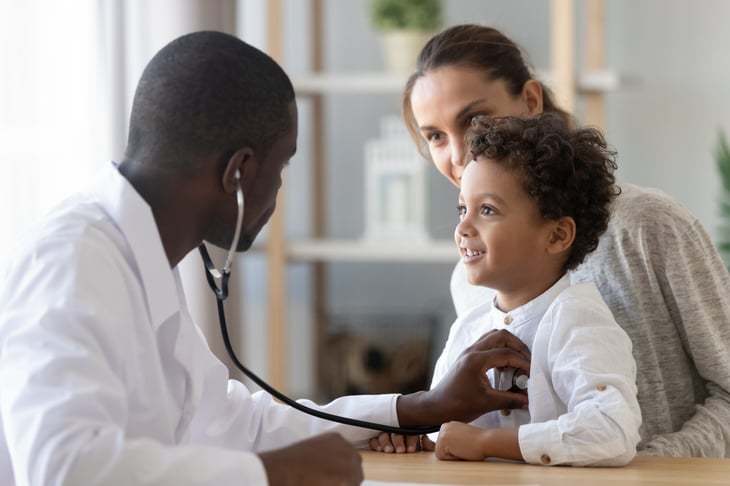 Doctor using a stethoscope on a patient