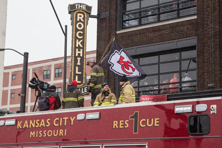 Kansas City, Missouri, firefighters ride a firetruck in a parade