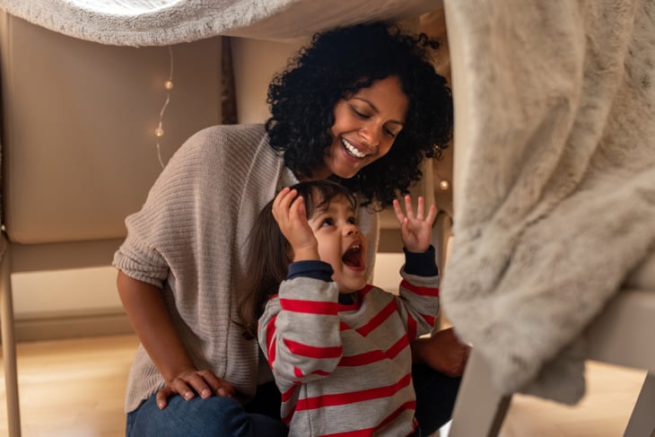 Mother and son in a blanket fort