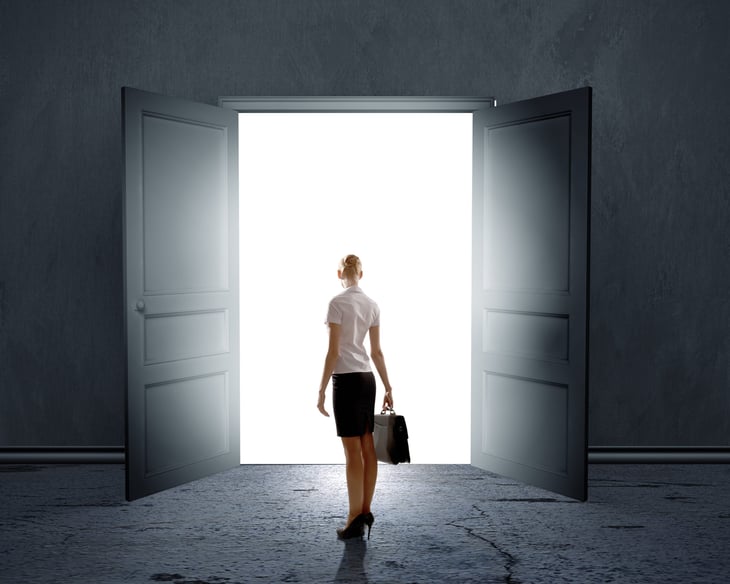 Woman stands in front of open doors