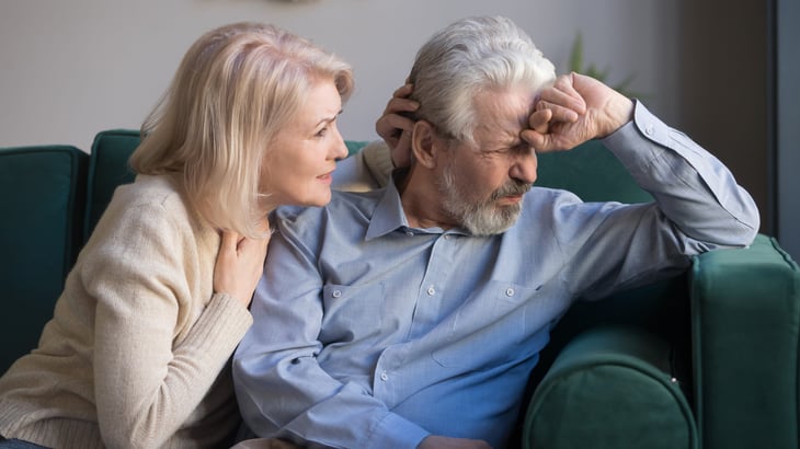 A woman comforts her upset senior husband
