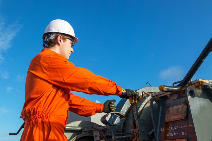 An engineer operates a hoist on a work site