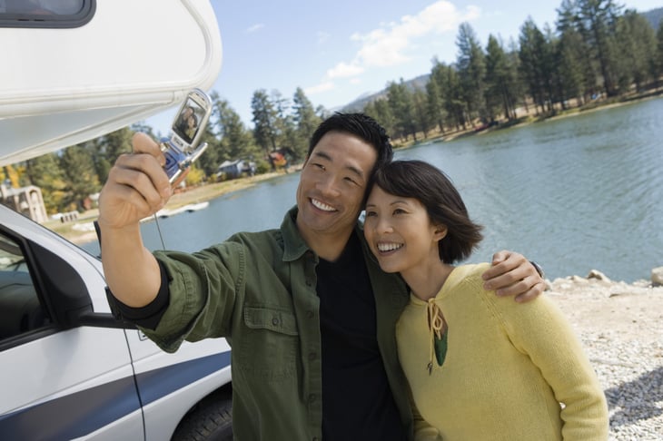 Couple taking a selfie with an RV