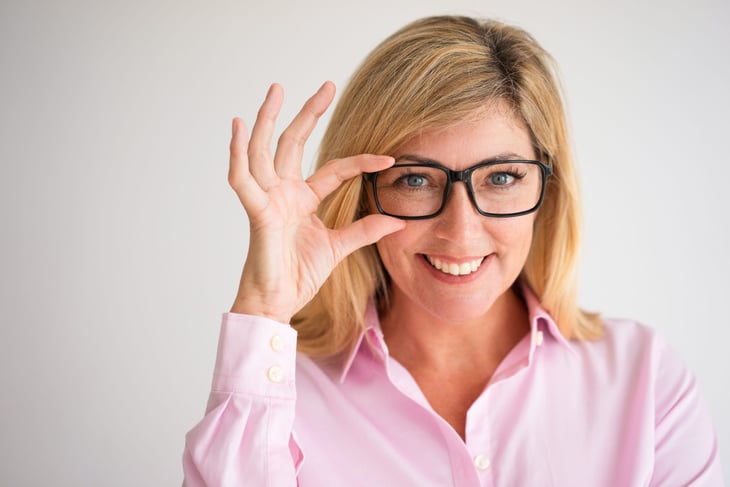 Woman touching glasses