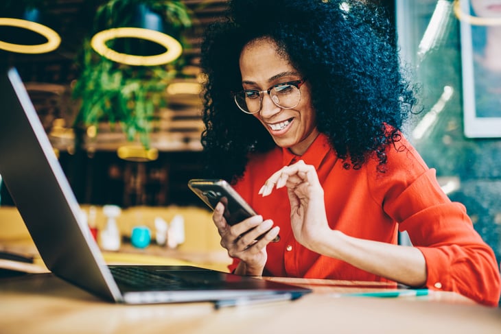 Woman with cellphone, laptop