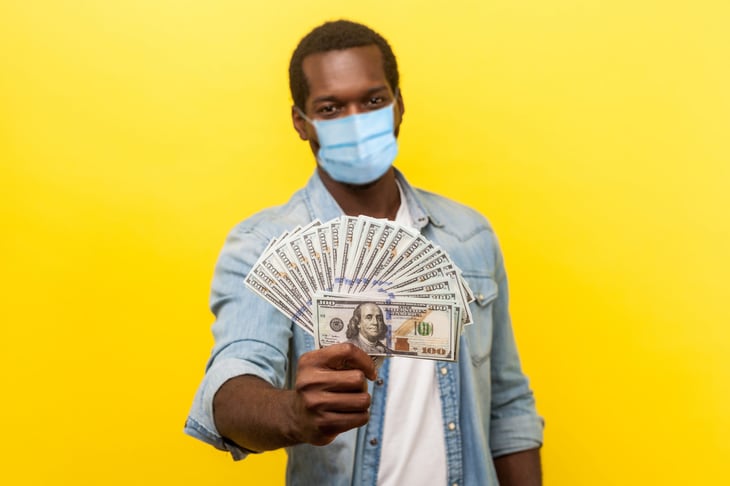 Man holding his second stimulus payment