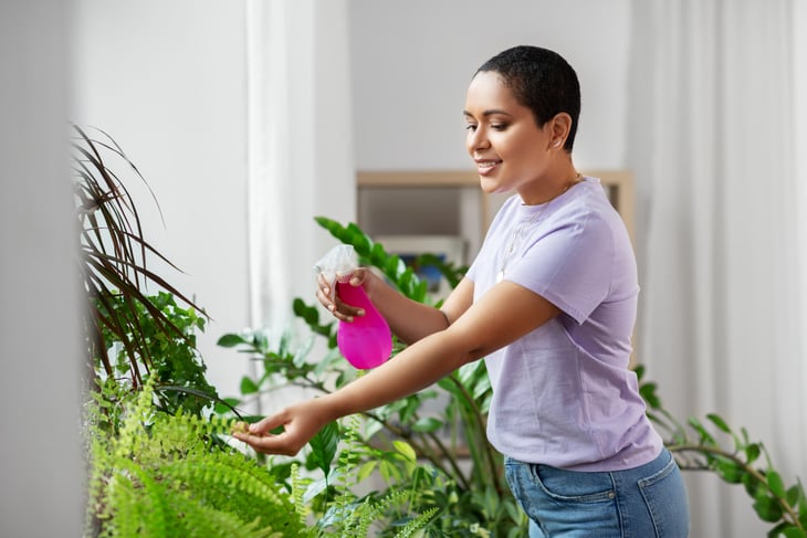 Woman watering houseplants