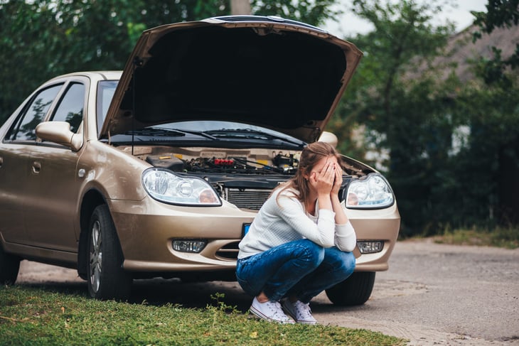 Woman with broken down car
