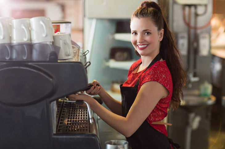 A 15-year-old girl working at a coffee shop prepares morning brew for customers