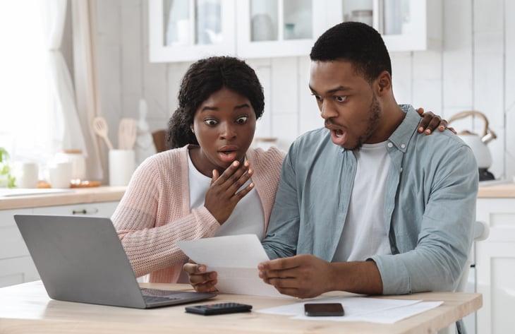 Shocked couple in debt